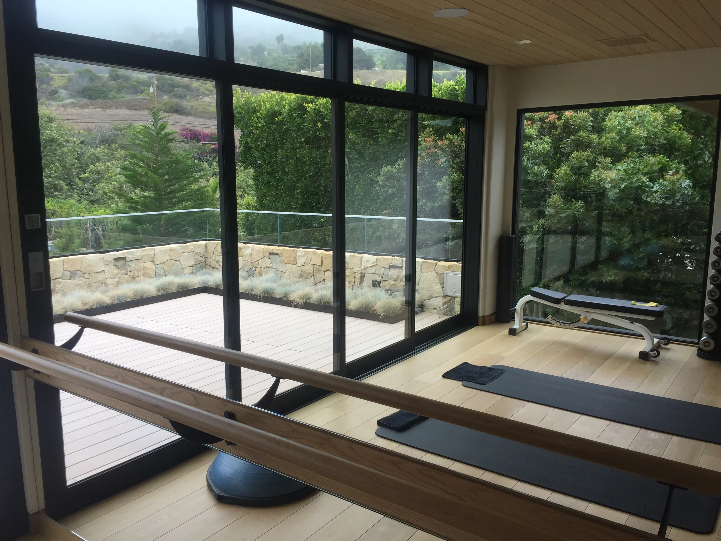 Black-framed sliding glass doors opening to a terrace