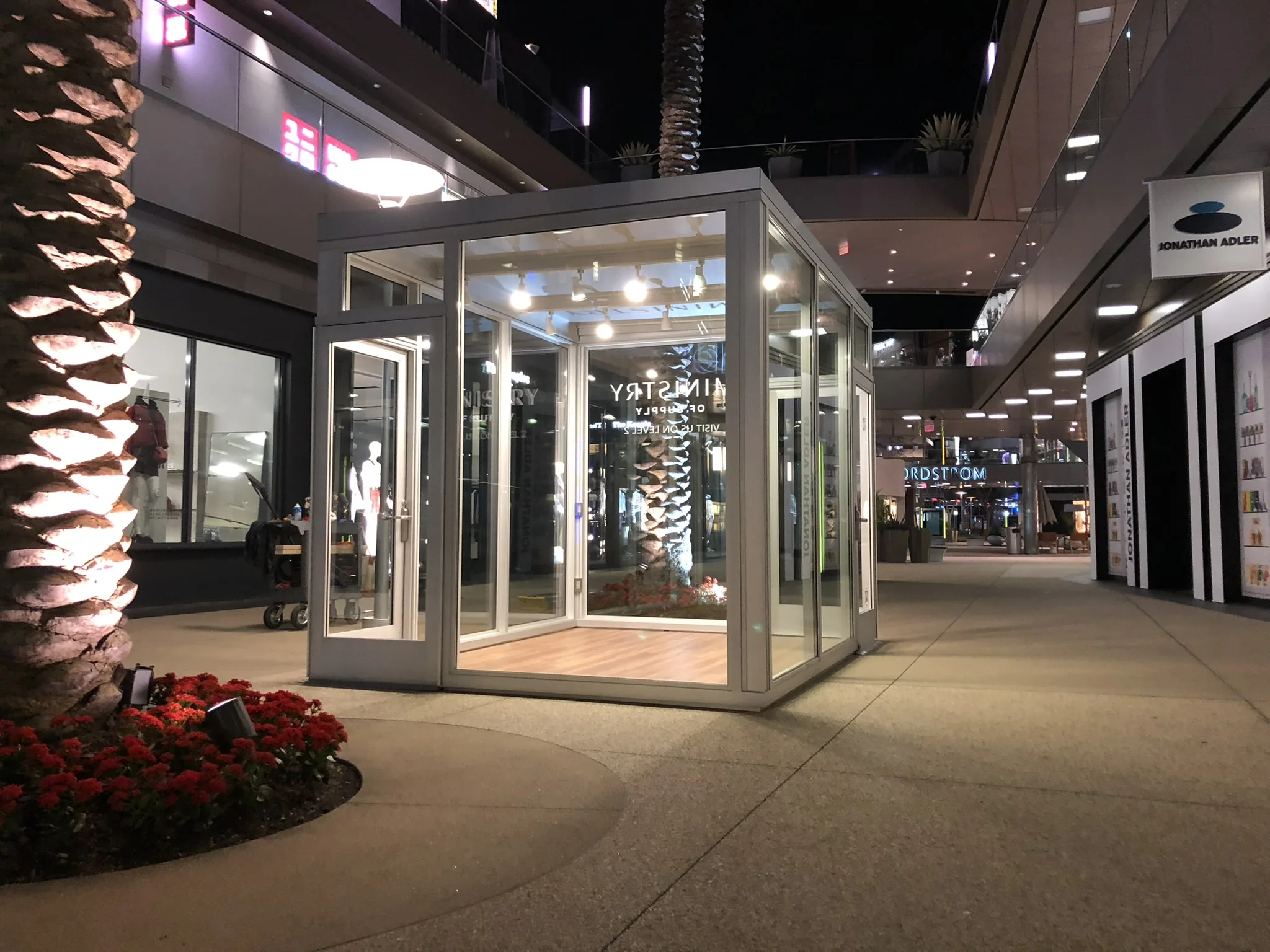 Illuminated commercial glass storefront at night