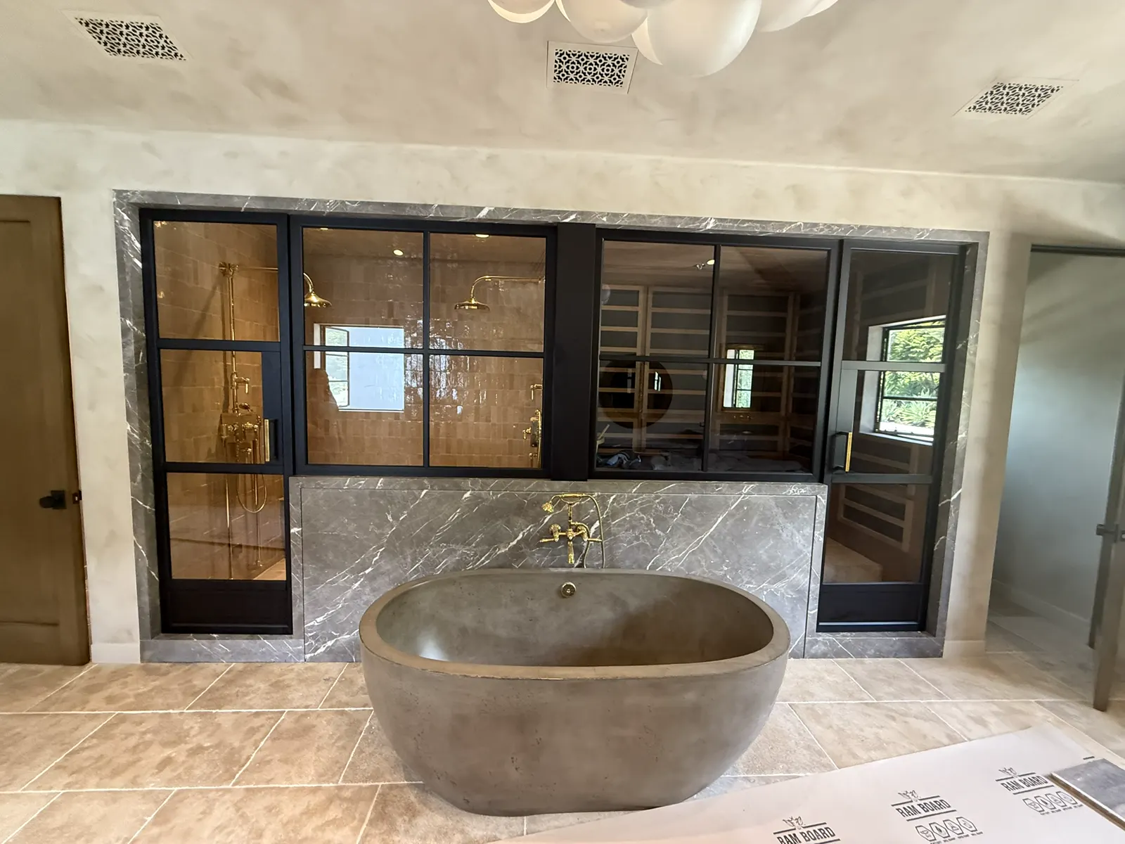 Black-framed glass-paned doors in a luxury bathroom