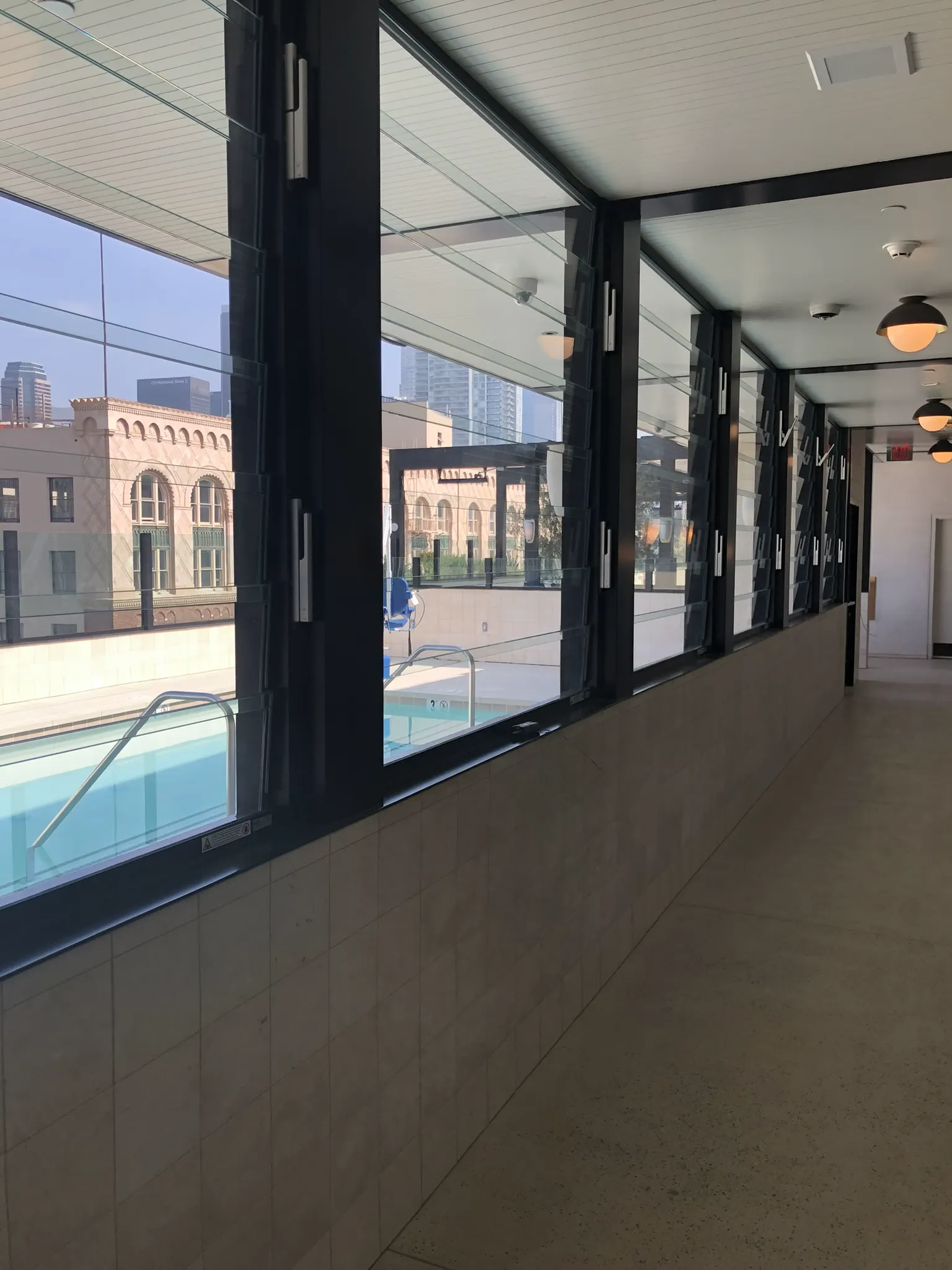 Black-framed glass doors looking out to a swimming pool