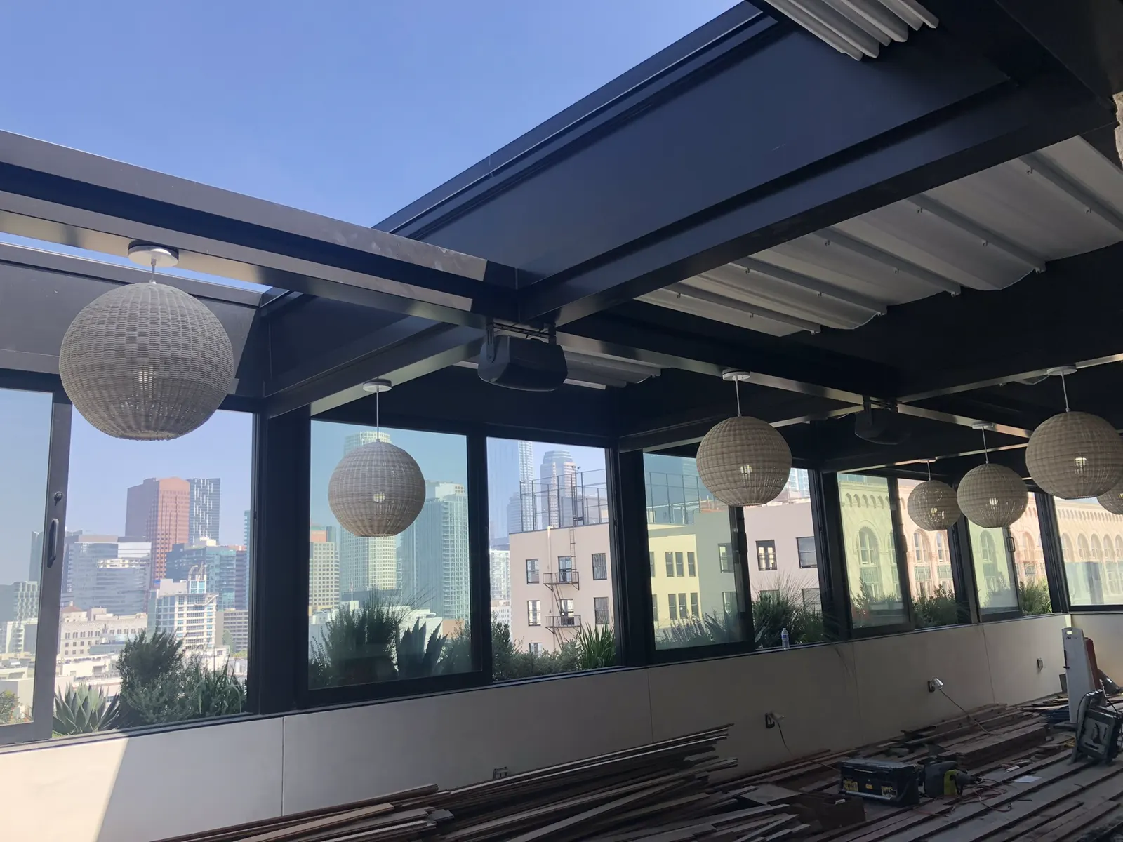 High-ceiling room with a wall of black-framed glass