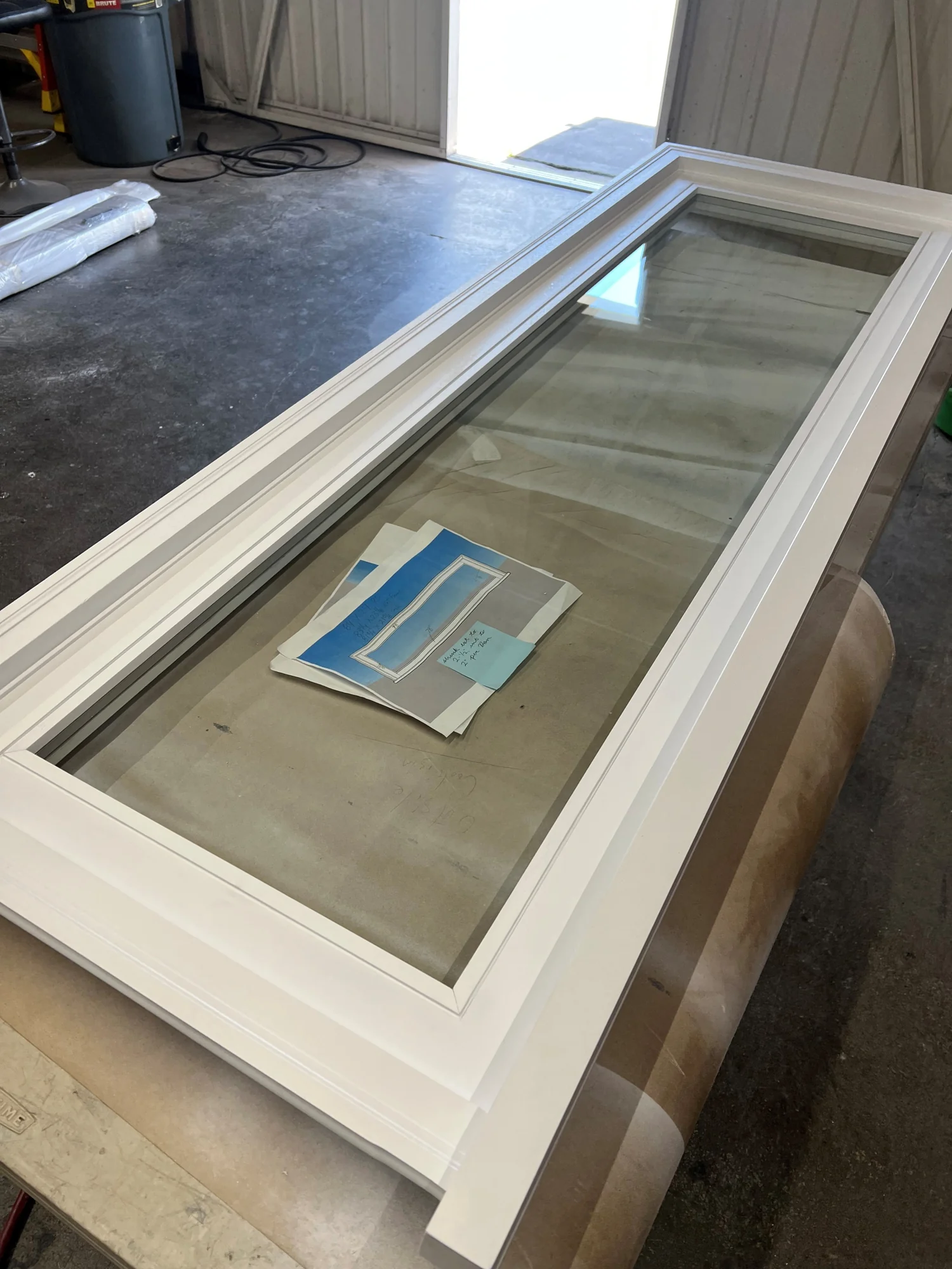 Custom white wood window with glass, fabricated in the shop
