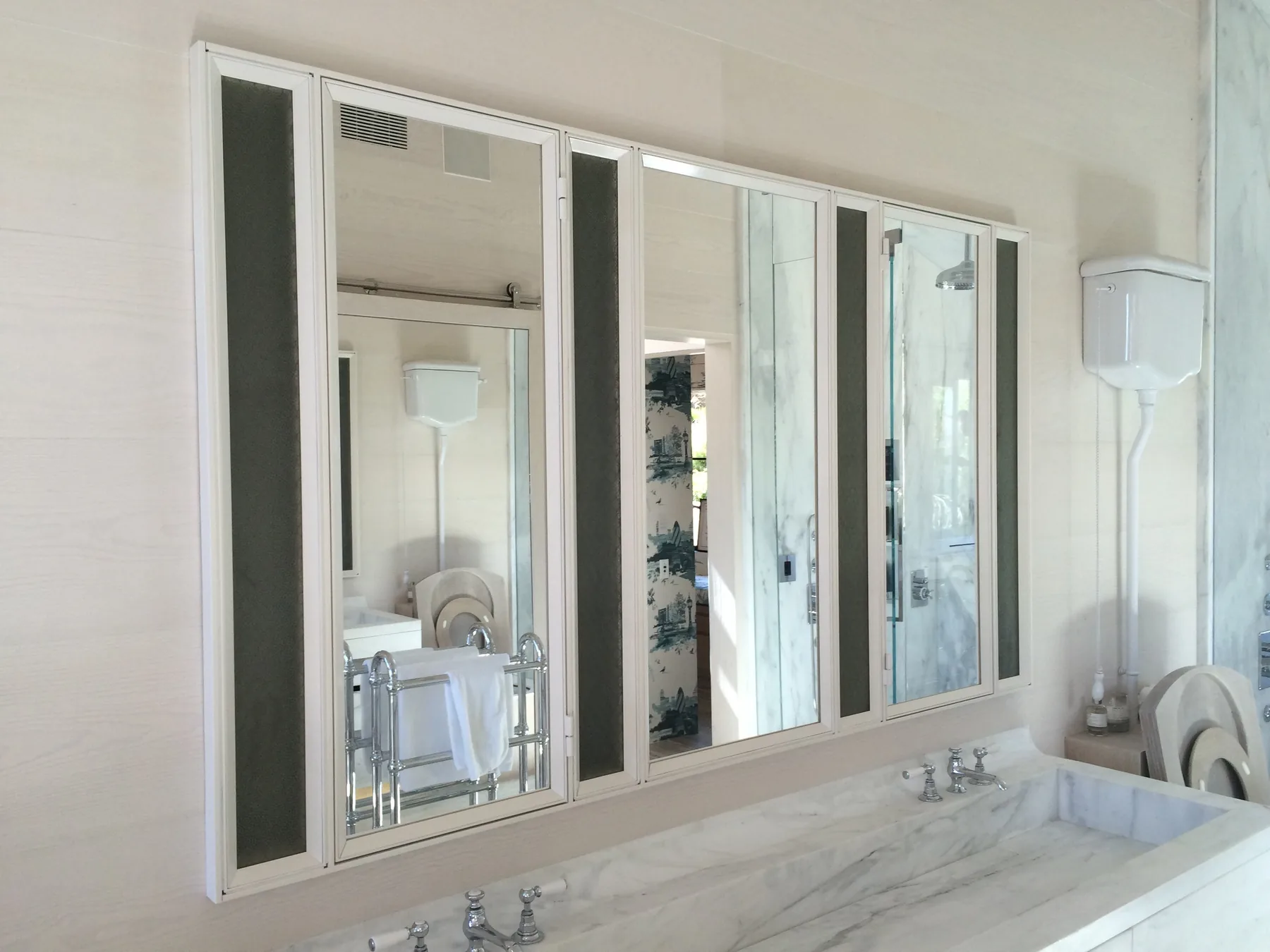 White metal medicine cabinet with mirrored doors and mesh panels