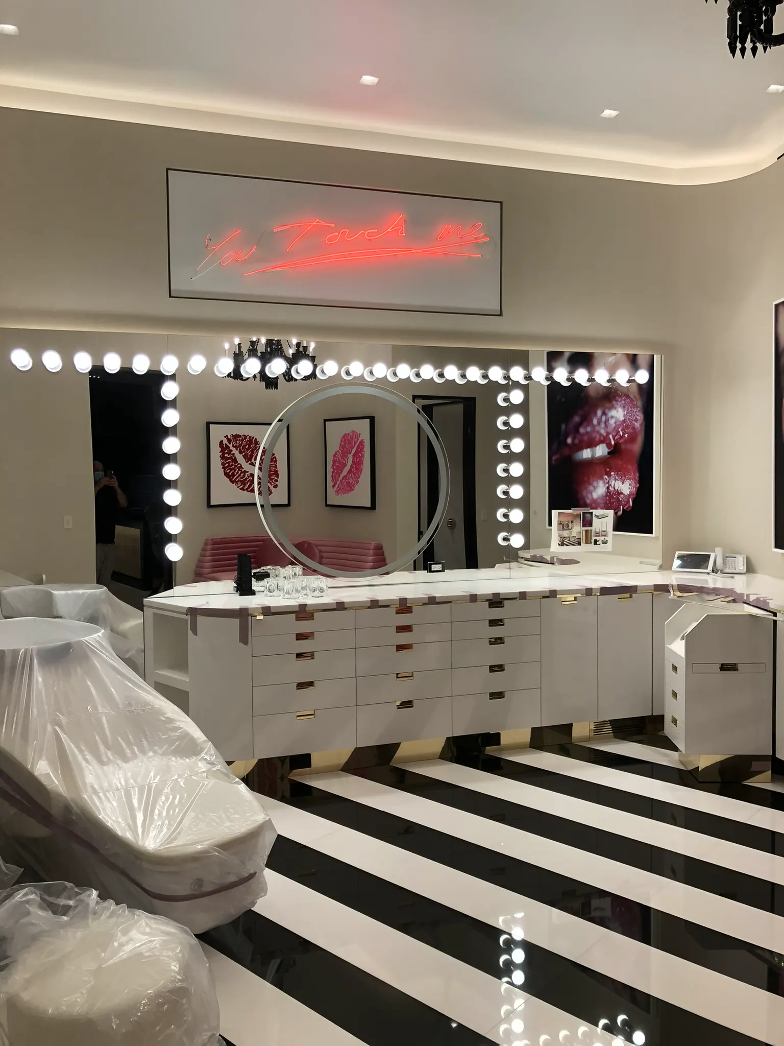Large vanity mirror surrounded by lights in a dressing room