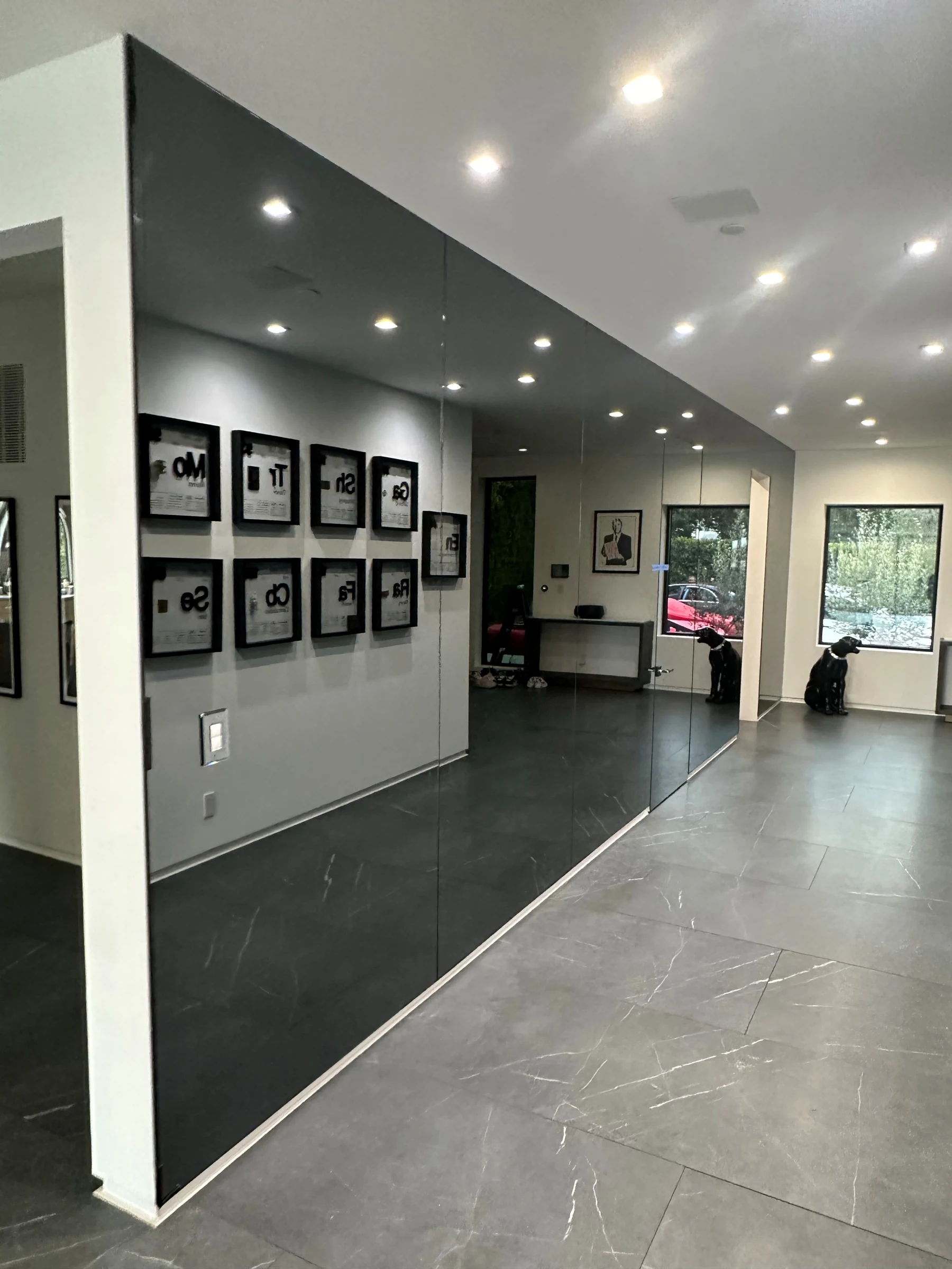 Custom oval mirror inset in a white framed panel