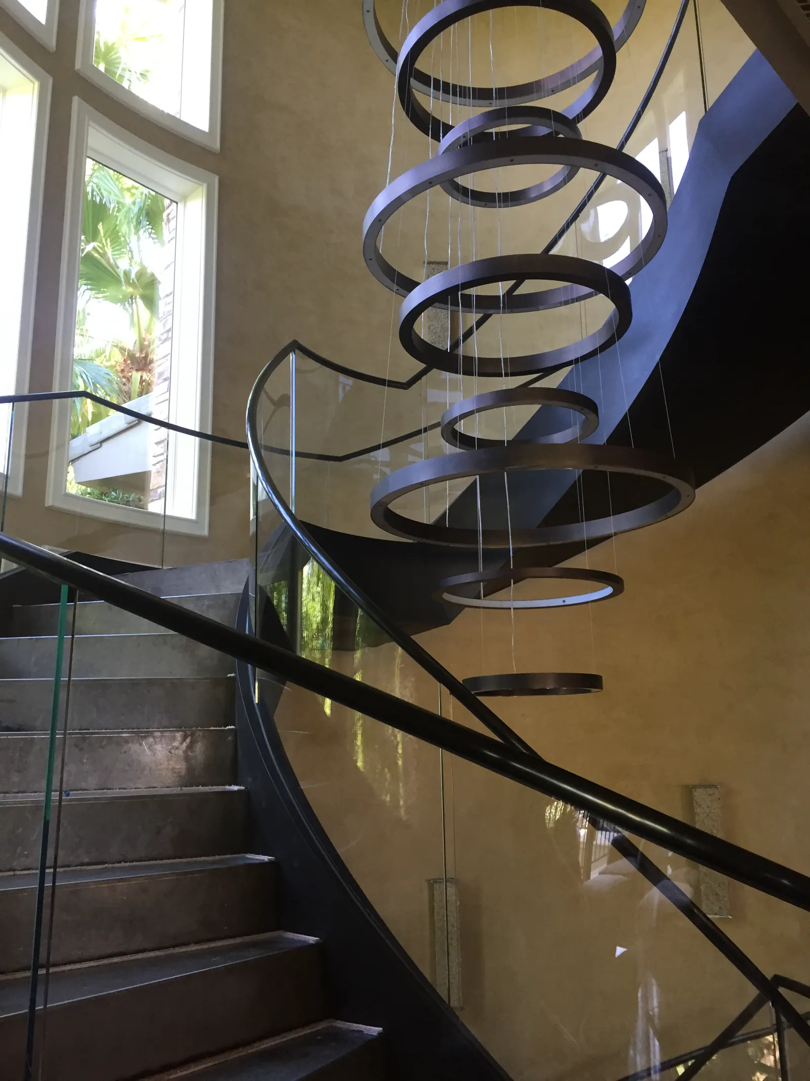 Curved glass railing following a spiral staircase