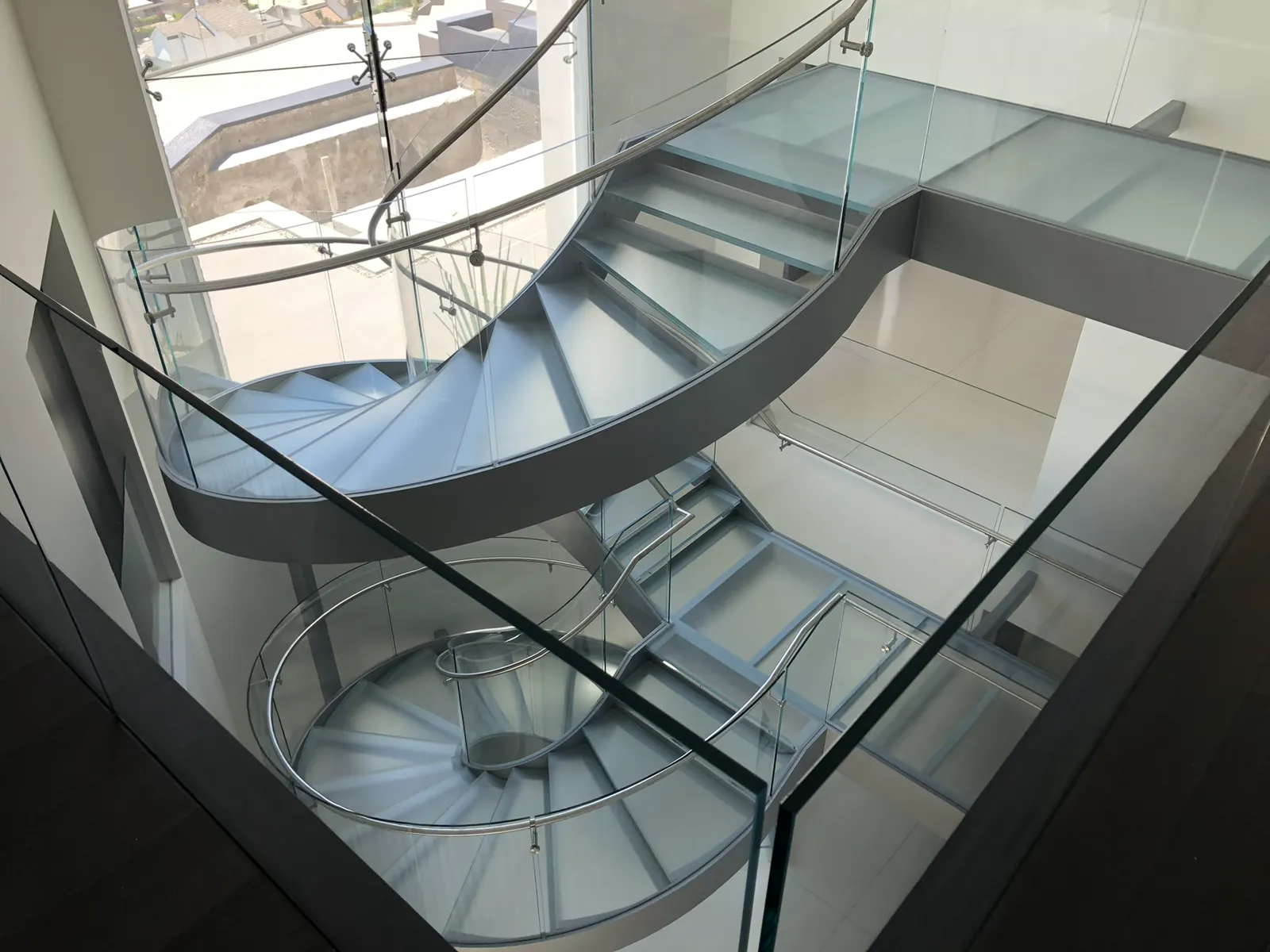 Spiral staircase with glass treads and glass railings