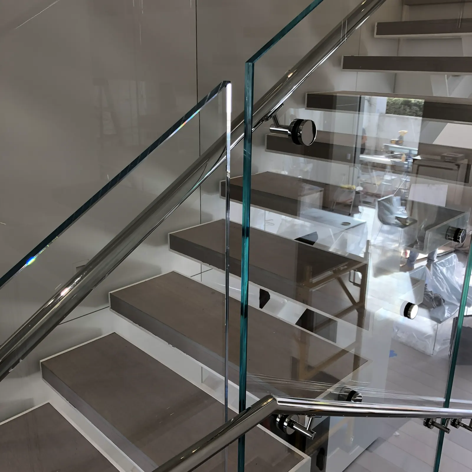 Glass stair railing mounted with stainless standoffs