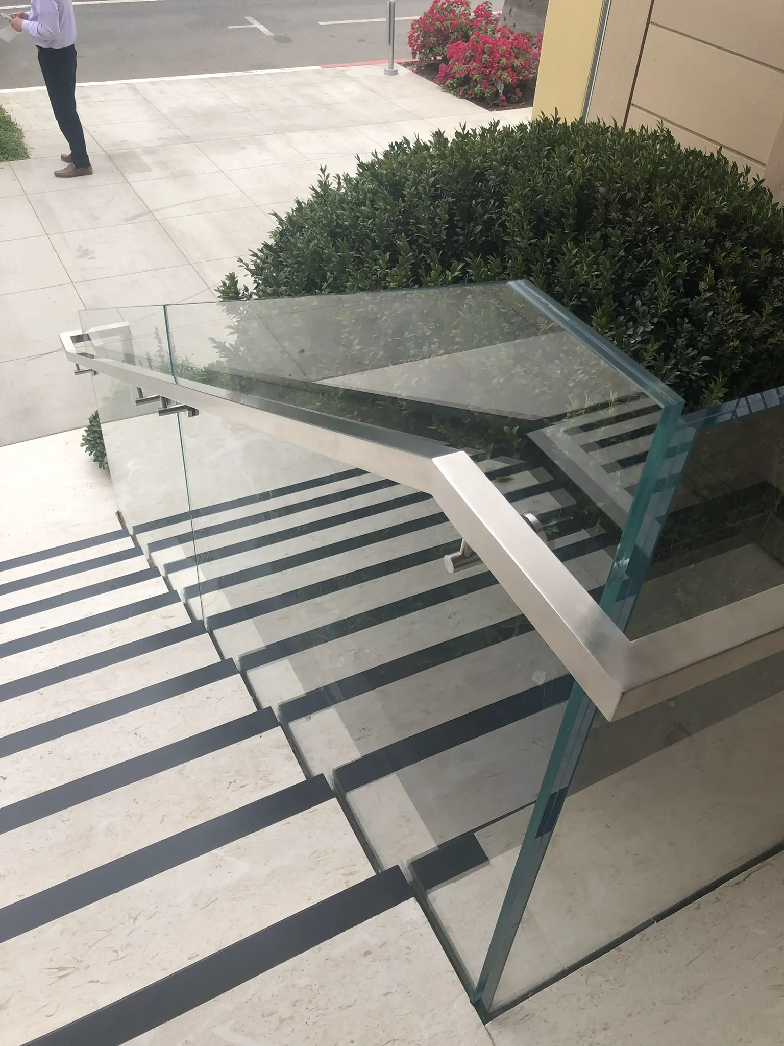 Frameless glass railing along outdoor concrete stairs