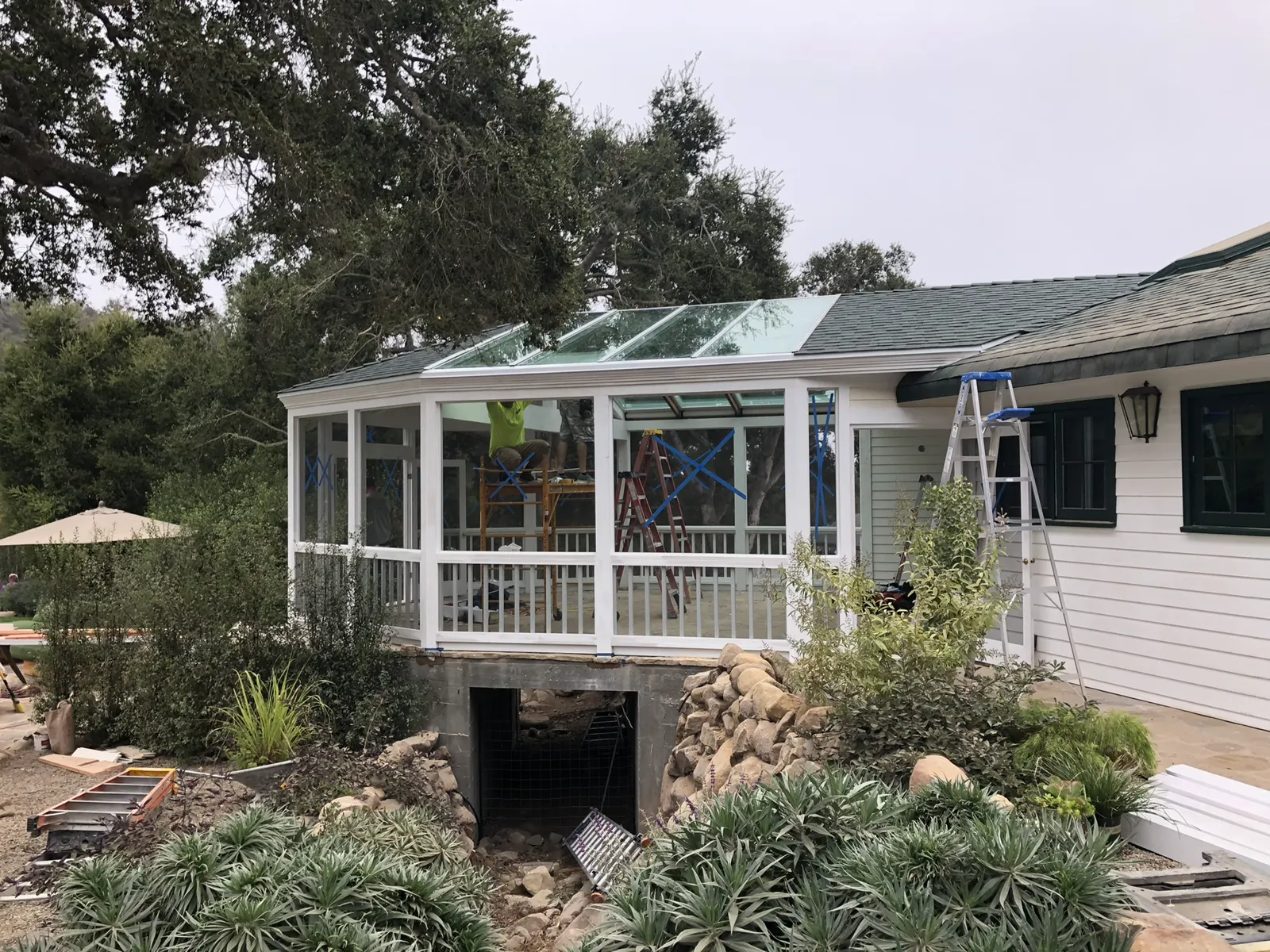 Glass-enclosed sunroom addition on a house