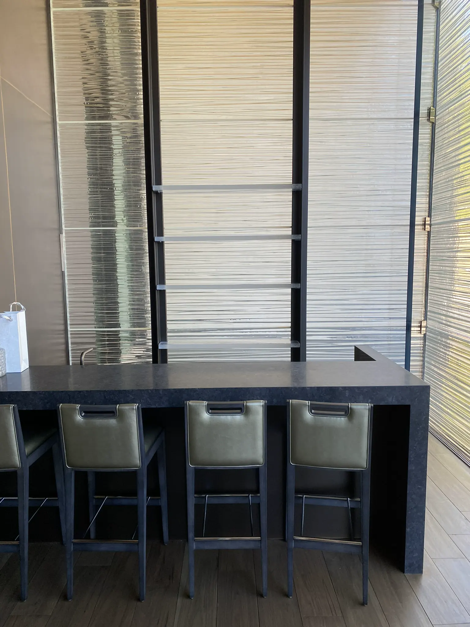 Thick textured glass shelves at a home bar