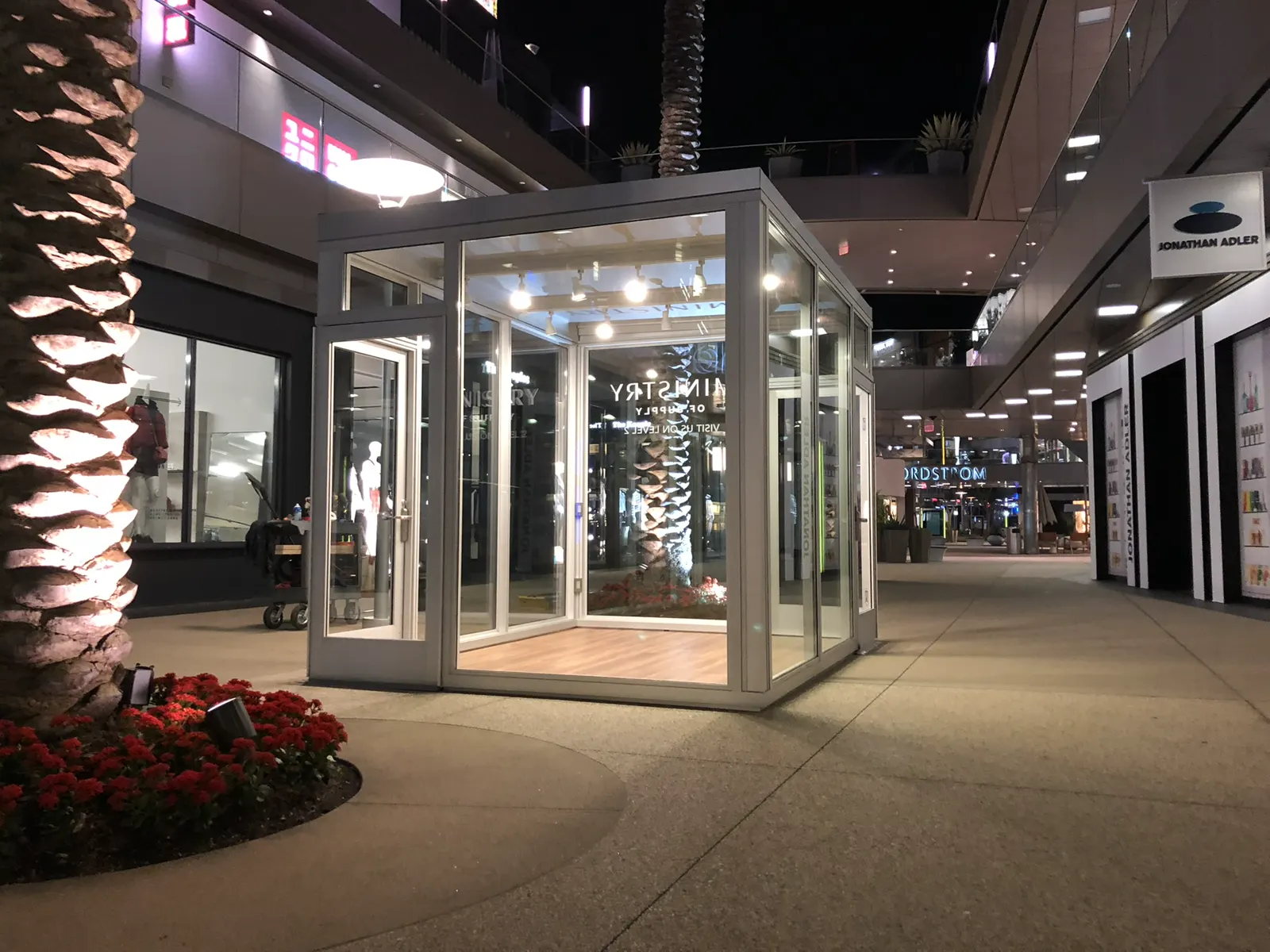 Illuminated glass-walled pavilion at night